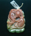 Thumbnail DSC07330.JPG: Item #DB10, Price $100.00 length 43mm, 33mm width, thickness 15mm at the top. Carved fancy jasper cut from one stone. It can be used as a pendant since it has a hole drilled in the top or added to your collection of fine carvings. The top side of the bead is carved in the maroon part of this stone. The back side is carved in the green part of this stone. Top side has carved fish shown in photo. Back side has carved lotus leaf.  